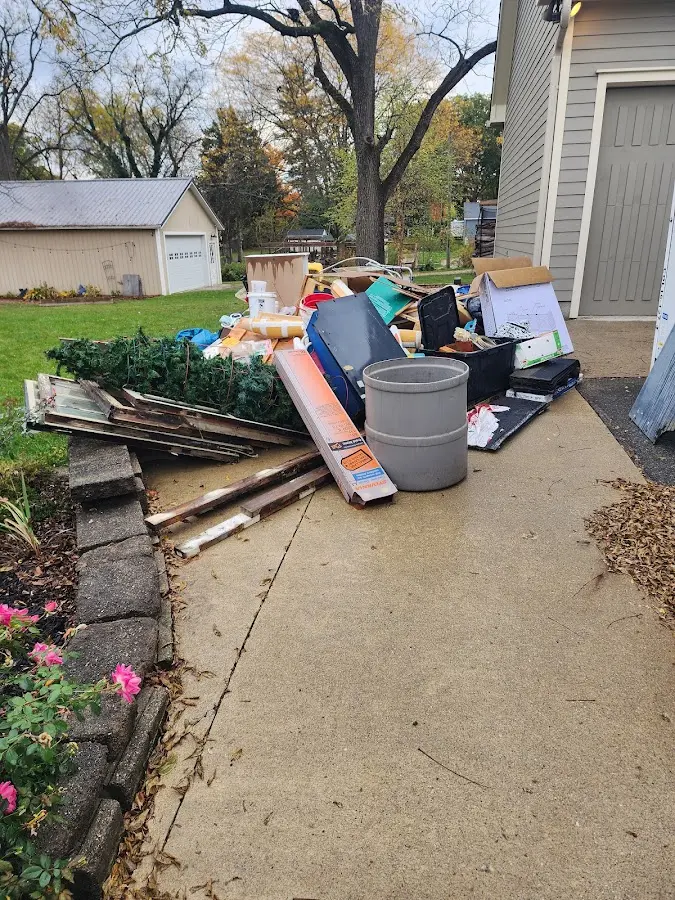 Dumpster being loaded with debris for 12 Yard Dumpster Rental in Bigfork